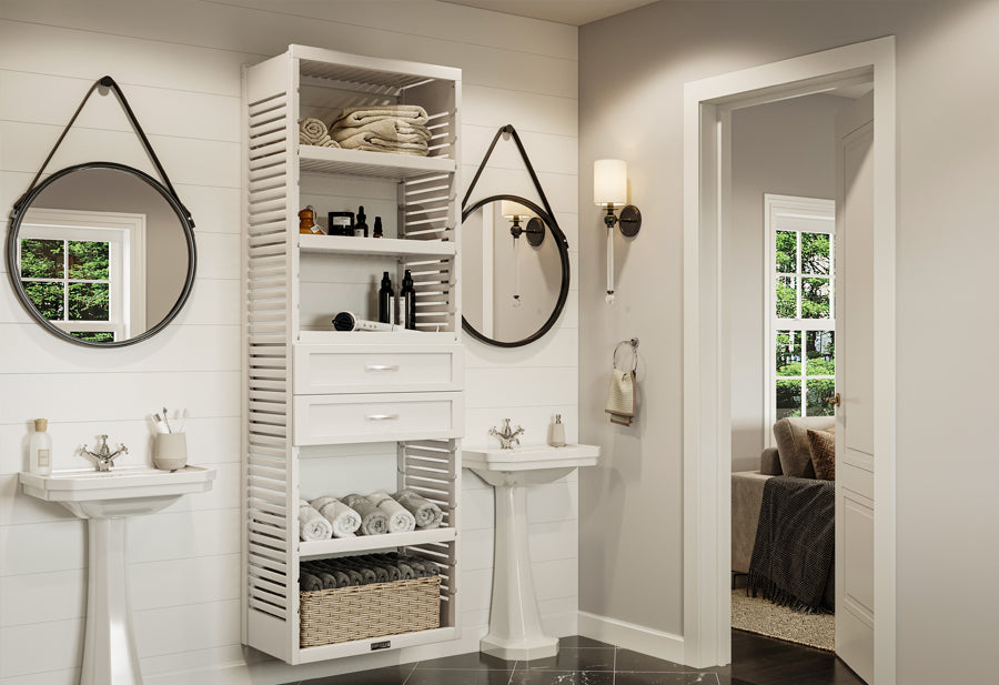 White bathroom storage tower organizing linens next to pedestal sink