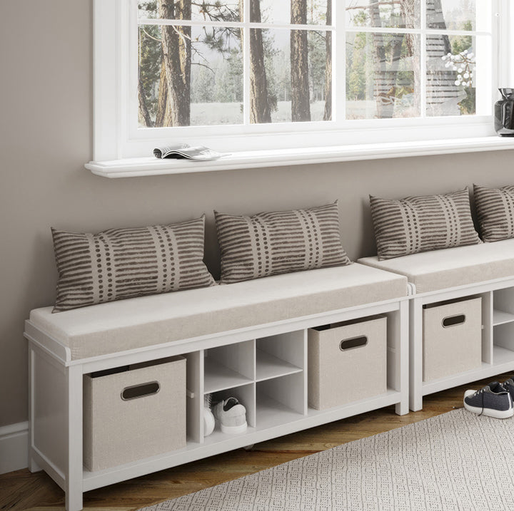 two entryway benches with storage cubbies placed under a large window